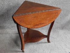 An Edwardian mahogany and satinwood inlaid drop flap occasional table on cabriole supports united by