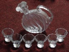 A set of six antique cut crystal shot glasses with faceted bases and a blown glass handled