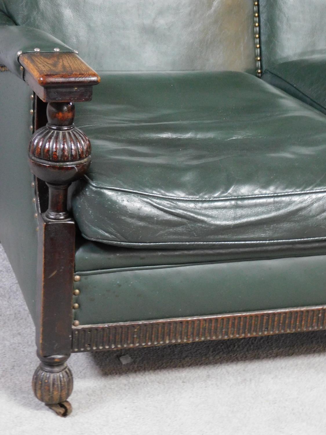 A mid 20th century carved oak frame leather upholstered two seater sofa on bulbous reeded - Image 2 of 7