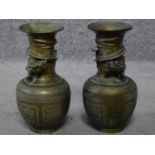 A pair of brass Chinese vases with engraved design depicting clouds, flowers, lucky bats and