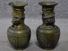 A pair of brass Chinese vases with engraved design depicting clouds, flowers, lucky bats and