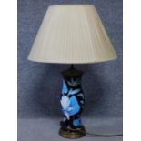 A vintage glass over metal table lamp with tropical flowers, foliage, birds and insects. Including a