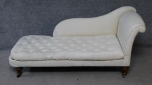 A Victorian mahogany chaise longue with buttoned squab cushion on turned tapering supports. H.79xW.