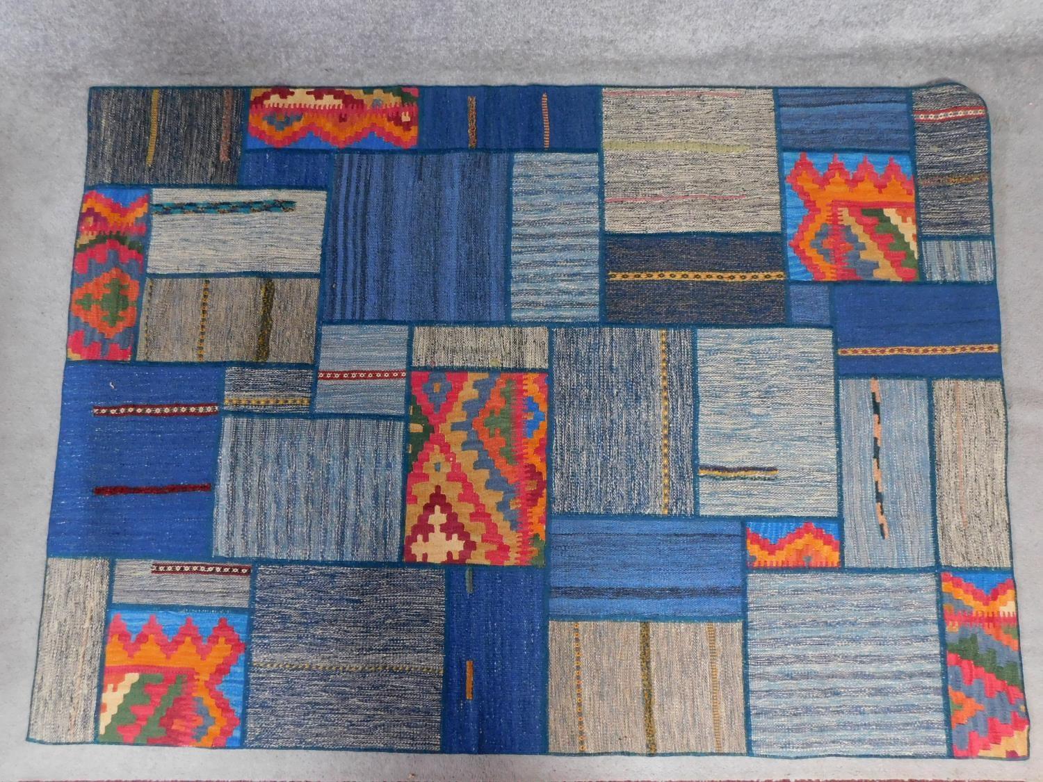 A modern geometric style rug of patchwork design. 200x141cm