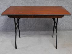 A metal framed folding trestle table. H.76 W.120 D.76cm