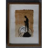 A framed and glazed watercolour of a silhouette of a soldier standing on rubble and barbed wire.