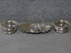 A pair of Martin Hall & Co Georgian pierced silver plated wine coasters with oak bases and a