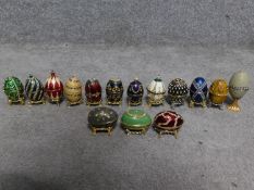 A collection of fifteen Faberge style enamel and diamante egg trinket boxes. All have magnetic