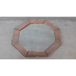 An Art Deco style mirrored peach glass octagonal bevelled wall mirror. H.80xW.80cm