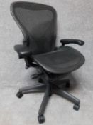 A contemporary Herman Miller Aeron ergonomic design office chair with reclining, swivelling and up