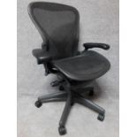 A contemporary Herman Miller Aeron ergonomic design office chair with reclining, swivelling and up