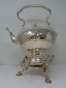 An antique white metal and ivory spirit kettle and stand. The kettle has a flower bud finial and