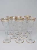 A set of eight St Louis crystal sherry glasses, with gilded scalloped detailing and gilded edge to