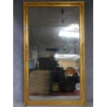 A very large early 19th century gilt framed and gesso moulded pier mirror with its original glass