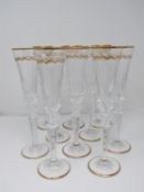 A set of ten St Louis Excellence crystal champagne glasses,with gilded scalloped detailing and