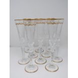 A set of ten St Louis Excellence crystal champagne glasses,with gilded scalloped detailing and