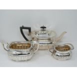 An Elkington and Co. silver three piece tea service, includes a teapot, sugar bowl and milk jug.