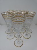 A set of eleven St Louis Excellence crystal large wine glasses, with gilded scalloped detailing