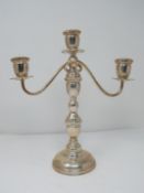 A continental silver three branch candelabra with weighted round base and twisted design. Stamped to