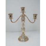 A continental silver three branch candelabra with weighted round base and twisted design. Stamped to