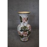 A large floor standing ceramic glazed Oriental style vase of bulbous form with lotus flower and