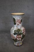 A large floor standing ceramic glazed Oriental style vase of bulbous form with lotus flower and