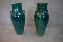 A pair of turquoise glazed Sharab wine vessels. H.78x24cm