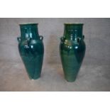 A pair of turquoise glazed Sharab wine vessels. H.78x24cm