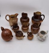 A collection of antique earthenware jugs and teapots and a hand painted porcelain oriental teapot.