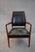 A mid 20th century vintage Danish teak framed armchair in leather upholstery. H.90x68cm