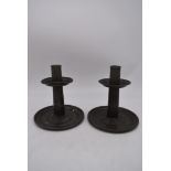 A pair of pewter Art's and Craft's candlesticks with stylised embossed decoration to the stem. H.