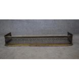 A 19th century pierced brass fire kerb. H.14x92x35cm