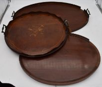 A late 19th century mahogany and satinwood inlaid twin handled tray and two other similar trays. L.