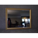 A large gilt framed wall mirror with bevelled plate. H.105x130cm