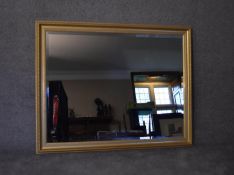 A large gilt framed wall mirror with bevelled plate. H.105x130cm