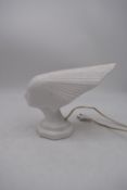 A vintage style white ceramic lamp in the form of the Spirit of the Wind. H.24x30cm