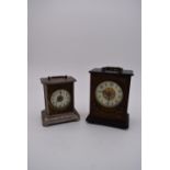 A brass cased carriage clock with engraved brass front with scrolling design and white enamel dial