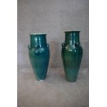 A pair of turquoise glazed Sharab wine vessels. H.78x24cm