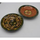 Two antique persian hand painted glazed ceramic dishes. One with a Persian deity surrounded by