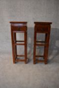 A pair of Chinese hardwood urn stands fitted frieze drawers. H.86x32cm