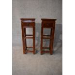 A pair of Chinese hardwood urn stands fitted frieze drawers. H.86x32cm