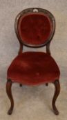 A Victorian mahogany framed balloon backed armchair on carved cabriole supports. H.85x43cm