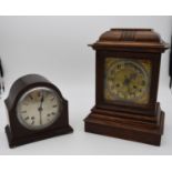 An oak cased bracket clock with brass dial and gilt metal pierced detailing to the corners and