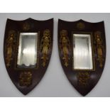 A pair of late 19th century mahogany framed shield shaped mirrors with original bevelled central
