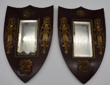 A pair of late 19th century mahogany framed shield shaped mirrors with original bevelled central