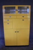 A large 1960's vintage kitchen cabinet with an arrangement of nine cupboards fitted with metal