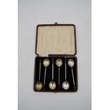 A set of cased Art Deco silver plate coffee spoons with shell bowls and bakelite coffee bean