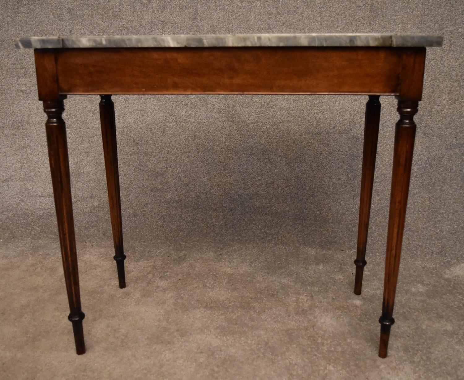 A 19th century mahogany console table with grey marble top on reeded tapering supports. H.75x82x43cm