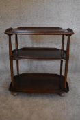 A vintage elm Ercol drinks trolley with three tiers on casters. H.77 x W.72cm