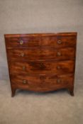 A Georgian mahogany and satinwood inlaid bowfronted chest of drawers on swept bracket feet. H.